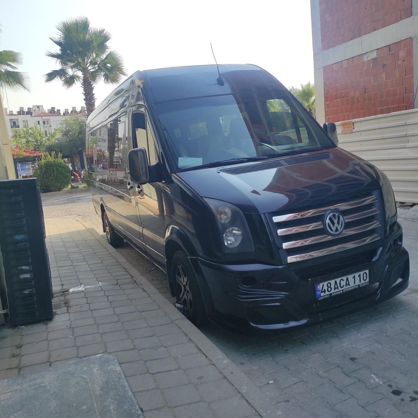 Akhan Turizm transfer minibus among palm trees